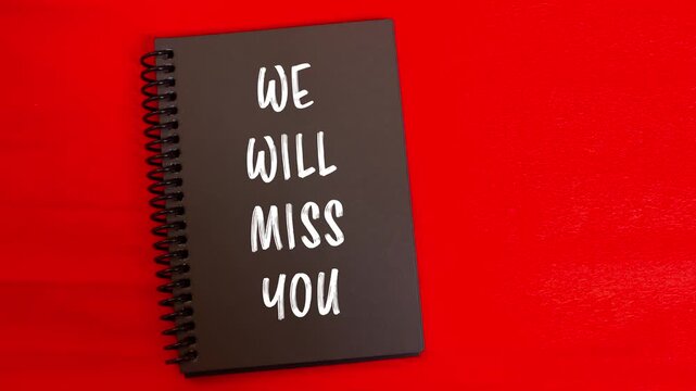 We will miss you message written on black notepad page with red background