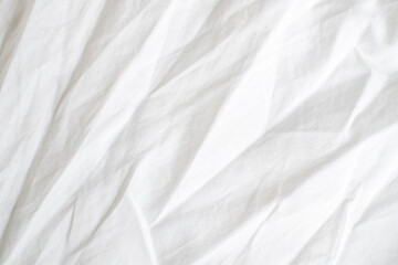 Obraz premium Abstract White Bedding Sheets or White wrinkled fabric background texture and Texture with copy-space :Creased or wrinkled white fabric,Soft focus