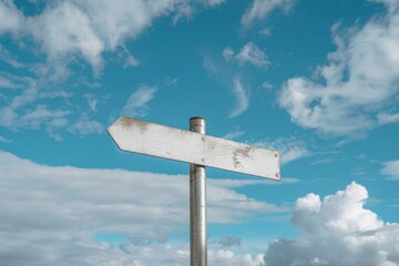 Metallic empty blank crossroad signpost mockup against blue sky and clouds