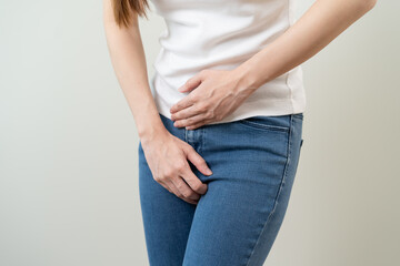 woman having painful lower stomach and hands holding pressing her crotch lower abdomen