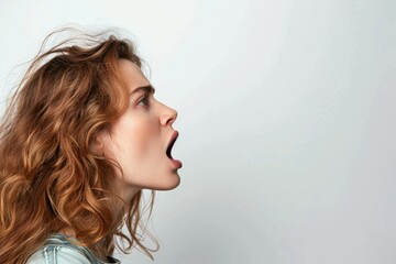 Side view of young woman shouting on white background copy space