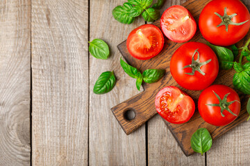 Fresh cherry tomatoes and fresh green basil on a textured background. Tomato sauce. Vegan. Ingredients for salad. Organic food. Place for text. Copy space.