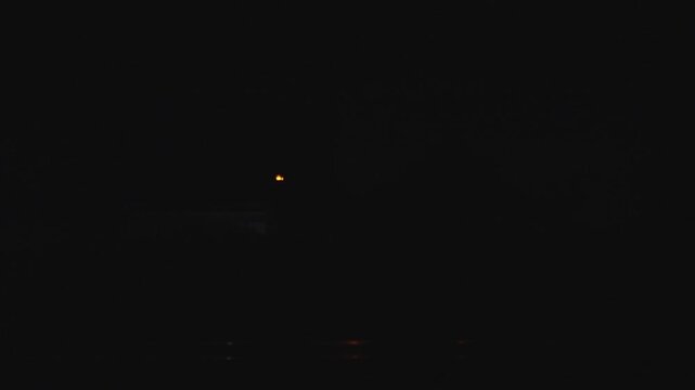 Thunderstorm bolts from the sky while driving along at a rainy day with dark background. Real lightning with stormy sky