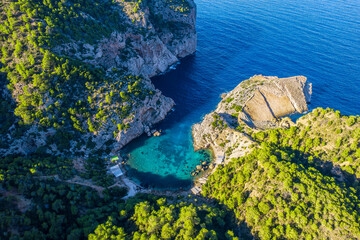 Aerial view of Cala Es Portixol, with turquoise waters and dramatic cliffs, Ibiza.