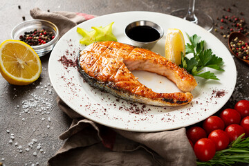 Close up of grilled salmon red fish steak on a plate
