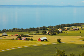 Scenic view of field by lake against sky in Gr&auml;nna