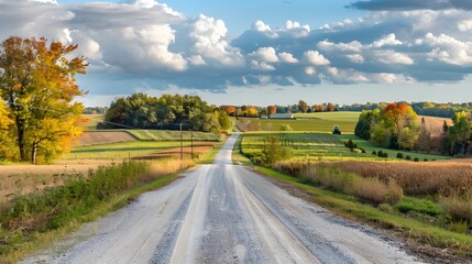 Obraz premium Scenic Rural Asphalt Road with Farm Tractor in Fall Countryside Landscape