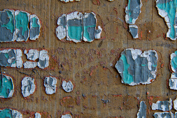 background of damaged wooden boards with patterns of peeling blue paint