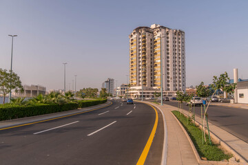 Obraz premium The city highway and the hotel building in the downtown of Jeddah, Saudi Arabia, a big city in the Middle East during the hot afternoon. 