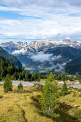 Alpine road, cloudy valley, Dolomites, Alps, Italy