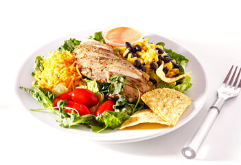 Southwest chicken salad in a white plate on a white background with copy space
