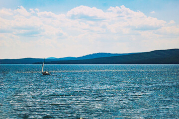 View of Lake Turgoyak. Natural landscape mountains, lake and yacht