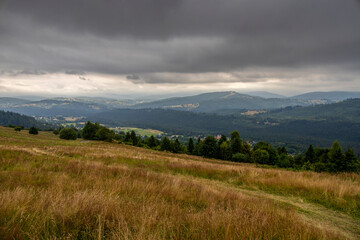 Landscape from a meadow on a slope on Ochodzita in Koniakow under a cloudy sky on a summer afternoon