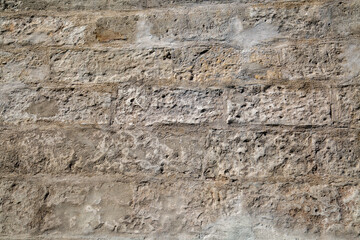 The background of the wall is made of gray rectangular stone. Backgrounds, textures, design.