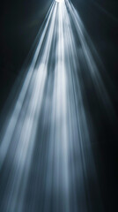 Light beams shining down in dark room