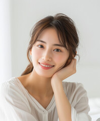 A woman with long brown hair is smiling and posing for a picture