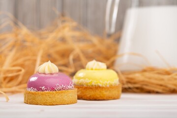 Cute sweet delicious cupcake on desk on pastel background