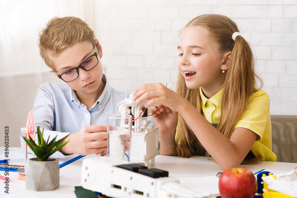 Poster two students, a boy and a girl, work together on a science project in a classroom setting. the boy i
