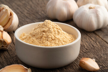 Food Additive Garlic Powder in white bowl, Natural Food Ingredient for Seasoning.