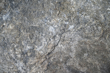 Close-up at roughly mortar rock surface, background and textured.