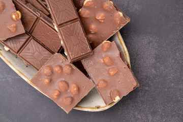 Chocolate cupcake with icing and chocolate bar in Dark lighting,Homemade delicious chocolate muffin on wooden background close-up