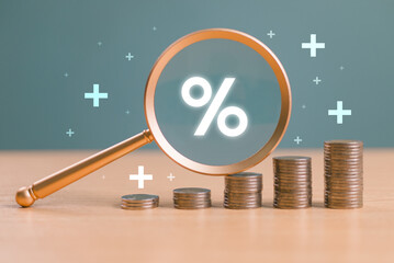 Interest rate rise, dividend money investment concept. Business provision of financial service. Gold magnifying glass finding on house loan interest rate percentage icon, mortgage rate blue background