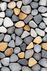 Flat lay of grey and beige pebbles on a dark background. Concept of natural textures, zen gardens, and minimalist design.