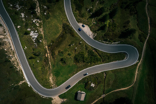 Aerial view of winding alpine road in Dolomites, South Tyrol, Italy. - Powered by Adobe