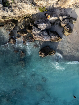 Aerial view of rocky cliff and turquoise water, Westpunt, Curacao.