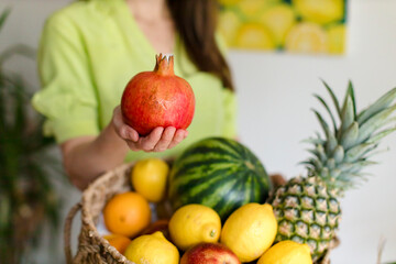 girl holds a pomegranate in her hand