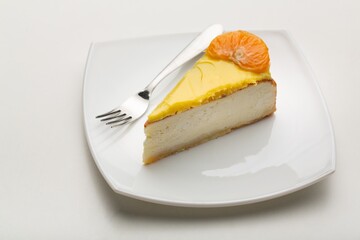 Delicious orange cheesecake with cream on plate