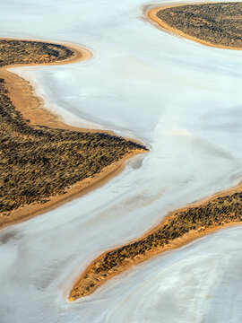 Aerial view of Lake Amadeus, salt lake, desert and arid coastline, Petermann, Australia.