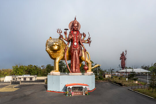 Aerial view of gigantic golden Durga Maa Bhavani statue in misty Grand Bassin, Savanne, Mauritius.