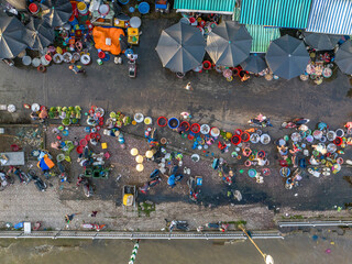 Aerial view of vibrant traditional street market with busy vendors and bustling city life, Ho Chi Minh City, Vietnam.