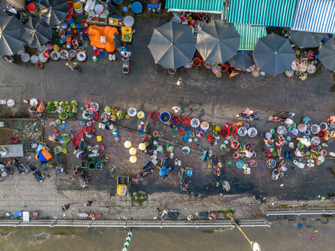 Aerial view of vibrant traditional street market with busy vendors and bustling city life, Ho Chi Minh City, Vietnam.