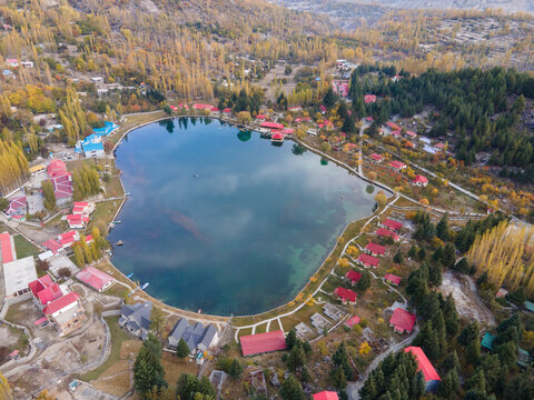 Aerial view of serene Kachura Lakes with reflection of village, houses, trees, and forest, Skardu, Gilgit-Baltistan, Pakistan.
