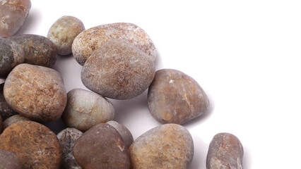 Pebbles piled on white background