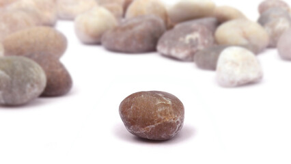 Pebbles piled on white background