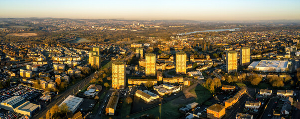 Aerial view of residential neighborhood with river, roads, and trees at sunset, Watsonville, Motherwell, United Kingdom.