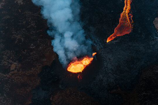 Aerial view of Litli Hrutur volcanic eruption with lava, smoke, and fire, Southern Peninsula Region, Iceland.
