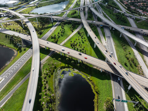 Aerial view of Sawgrass Interchange with highway, overpass, cars, and lakes, Davie, Florida, United States.