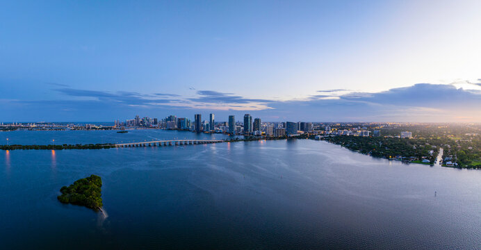 Aerial view of Miami skyline at sunset over Biscayne Bay and Oleta River State Park, Florida, United States.