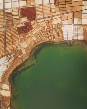 Aerial view of salt marshes and lagoon with geometric patterns, Laguna de Janubio, Salinas de Janubio, Salt Marshes, Yaiza, Lanzarote, Canary Islands, Spain.