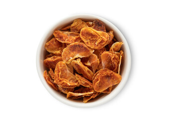 Bowl with dried sweet tangerine mandarine bites isolated on white background.Top view.