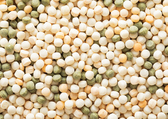 Assorted mix of raw healthy dry couscous grain seeds textured background.Macro.