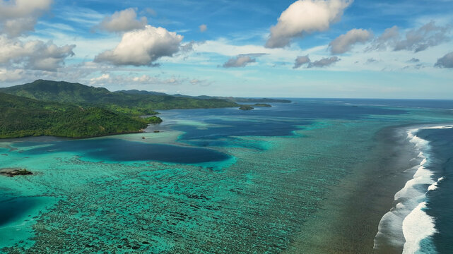 Aerial view of tropical island with reef and turquoise water, Eastern Fiji.