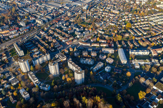 Aerial view of modern cityscape with dense housing and greenery in autumn, Biel, Bern, Switzerland.