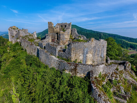 Aerial view of ancient Castle Ruin Alt-Bechburg amidst forest and hills, Holderbank, Switzerland.