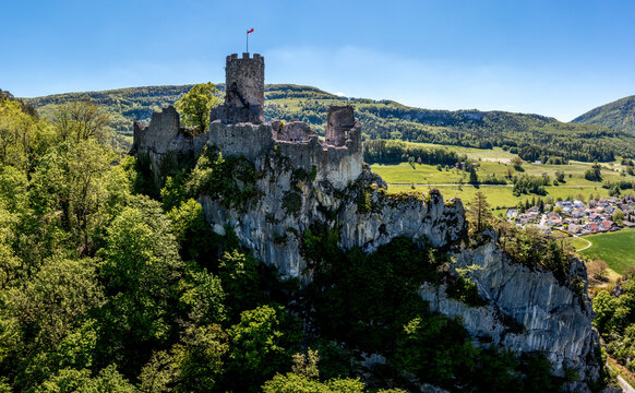 Aerial view of Castle Ruin Neu-Falkenstein surrounded by forest and village, Balsthal, Switzerland.