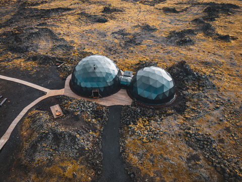 Aerial view of geodesic domes in volcanic terrain, Arora Base Camp, Hafnarfjordur, Iceland.